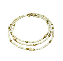 Load image into Gallery viewer, A multi-strand beaded necklace featuring off-white beads and metallic gold accents, displayed on a clean white background.