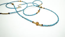 Load image into Gallery viewer, Beaded necklace with blue, gold, and brown beads on a white background
