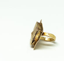 Load image into Gallery viewer, A textured gold ring with a sculptural, organic-shaped top, photographed on a clean white background.
