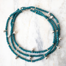 Load image into Gallery viewer, Enticing teal blue Javanese glass beads mingle playfully with gold or silver brass India Dancing Bells.  Named for Shiva Nataraja, or Lord of the Dance, let this substantial, statement-making wrap inspire you to move freely and with abandon...
