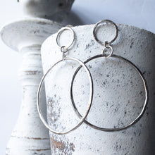 Load image into Gallery viewer, Your Favorite Bold Statement Hoop but just a lil&#39; bit bigger and a lot lighter.  Infinity Statement Hoops in Sterling Silver.  Each earring designed and handmade by the artist.  Each earring is individual, hand hammered and imbued with attitude. The perfect earring for a long night out or with friends on the porch.  3 inches / 7.5 cm long / 2 inches / 5 cm in diameter. Substantial but lighter and bolder. Sterling silver posts  Sterling Silver Hoops  All Sterling Silver is recycled and made in the USA
