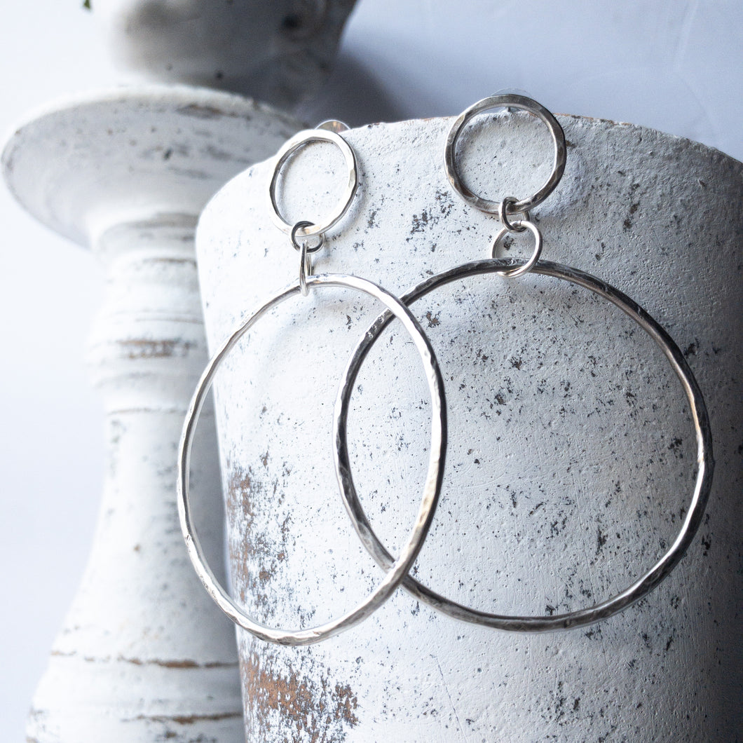 Your Favorite Bold Statement Hoop but just a lil' bit bigger and a lot lighter.  Infinity Statement Hoops in Sterling Silver.  Each earring designed and handmade by the artist.  Each earring is individual, hand hammered and imbued with attitude. The perfect earring for a long night out or with friends on the porch.  3 inches / 7.5 cm long / 2 inches / 5 cm in diameter. Substantial but lighter and bolder. Sterling silver posts  Sterling Silver Hoops  All Sterling Silver is recycled and made in the USA