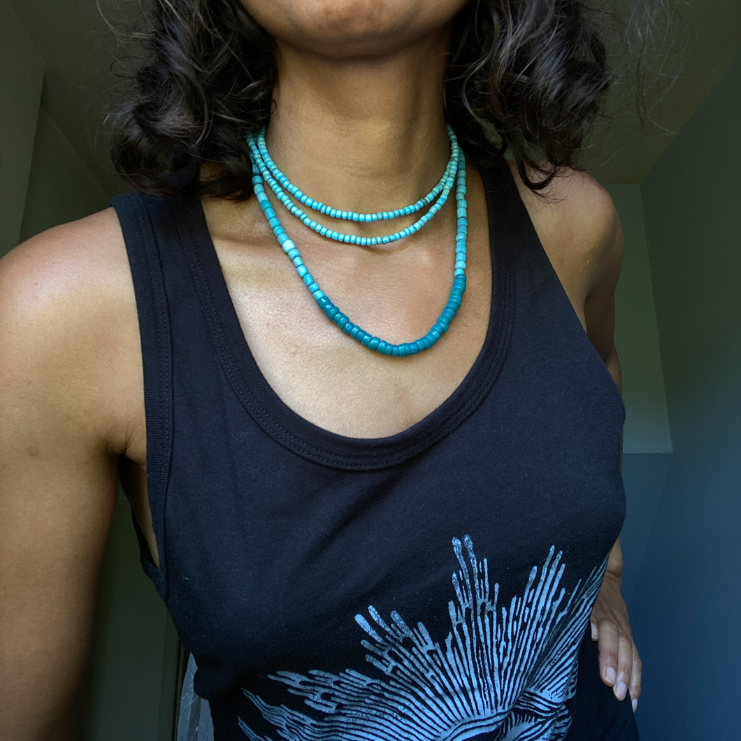Blue Bliss Wrap brings together 3 types of handmade blue beads: Teal Blue Javanese Glass, Cadet Blue African Gooseberry beads, and Denim Blue African Goomba beads