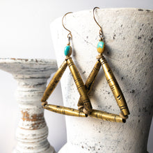 Load image into Gallery viewer, Covering three continents, the Turquesa Africana Earrings speak directly to your inner Gypsy.  Campitos Turquoise from Mexico (turquesa) share the spotlight with handmade, 30 year old Toureg Beads from Mali.  These are supported by handmade Columbian beads and handmade gold fill ear wires, US, all brought together in the symbolic shape of the triangle.  Throw in some Ethiopian brass heishi for balance.  8.25cm / 3.5 in long
